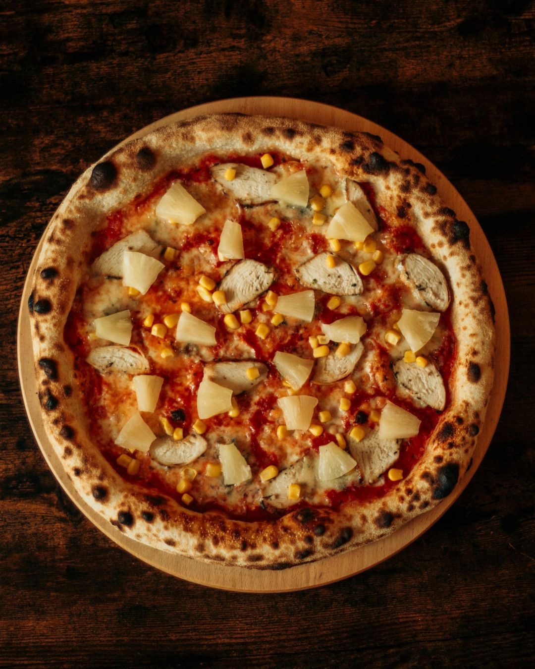 Hawaiian pizza with chicken, pineapple and corn